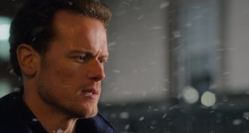 Movie still from “Love Again” (2023), directed by Jim Strouse – A man's face in the snow; Close Up shot, Over the shoulder angle