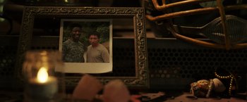 Movie still from “Love and Monsters” (2020), directed by Michael Matthews – A picture of two people in a picture frame on a table; Extreme Close Up shot, High angle