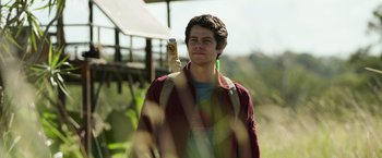Movie still from “Love and Monsters” (2020), directed by Michael Matthews – A young man holding up a can of soda in his hand; Medium shot, Low angle