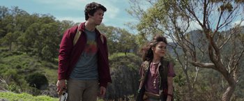 Movie still from “Love and Monsters” (2020), directed by Michael Matthews – A man and a woman walking through a field; Medium shot, Low angle