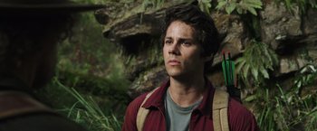 Movie still from “Love and Monsters” (2020), directed by Michael Matthews – A young man standing in front of a rock wall; Close Up shot, Low angle