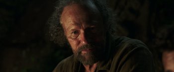 Movie still from “Love and Monsters” (2020), directed by Michael Matthews – An old man with a beard and a mustache; Close Up shot, Low angle