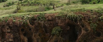 Movie still from “Love and Monsters” (2020), directed by Michael Matthews – A couple of people standing on top of a cliff; Extreme Wide shot, Overhead angle