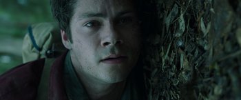 Movie still from “Love and Monsters” (2020), directed by Michael Matthews – A man's face in the woods; Close Up shot, Low angle