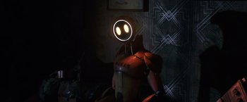 Movie still from “Love and Monsters” (2020), directed by Michael Matthews – A yellow and red robot with a glowing face; Medium shot, Low angle
