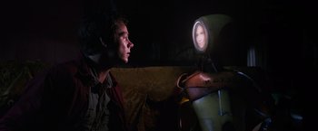 Movie still from “Love and Monsters” (2020), directed by Michael Matthews – A man looking at a woman in a mirror; Close Up shot, Over the shoulder angle