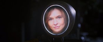 Movie still from “Love and Monsters” (2020), directed by Michael Matthews – A woman's face is reflected in a round mirror; Close Up shot, Overhead angle