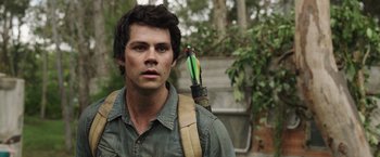 Movie still from “Love and Monsters” (2020), directed by Michael Matthews – A young man holding an arrow in his back pack; Close Up shot, Over the shoulder angle