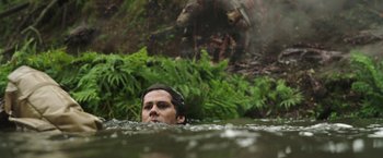 Movie still from “Love and Monsters” (2020), directed by Michael Matthews – A man swimming in a body of water; Close Up shot, High angle