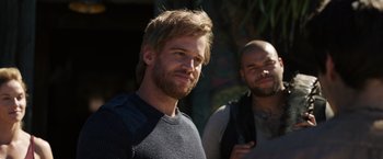 Movie still from “Love and Monsters” (2020), directed by Michael Matthews – A man standing next to another man with a beard; Close Up shot, Over the shoulder angle