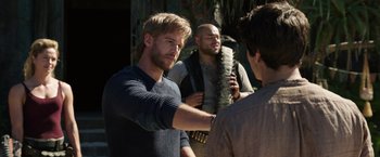 Movie still from “Love and Monsters” (2020), directed by Michael Matthews – Three men are standing in front of each other; Medium shot, Over the shoulder angle