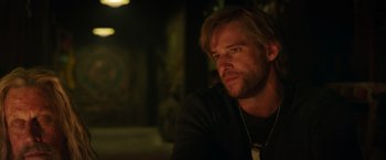 Movie still from “Love and Monsters” (2020), directed by Michael Matthews – A person sitting at a table; Close Up shot, Over the shoulder angle