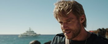Movie still from “Love and Monsters” (2020), directed by Michael Matthews – A man's face near the ocean; Close Up shot, Over the shoulder angle