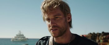 Movie still from “Love and Monsters” (2020), directed by Michael Matthews – A person wearing a necklace; Close Up shot, Over the shoulder angle