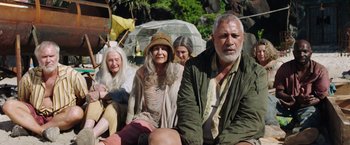 Movie still from “Love and Monsters” (2020), directed by Michael Matthews – A group of people sitting next to each other on the ground; Medium shot, Low angle