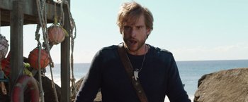 Movie still from “Love and Monsters” (2020), directed by Michael Matthews – A person wearing a sweater; Medium shot, Low angle