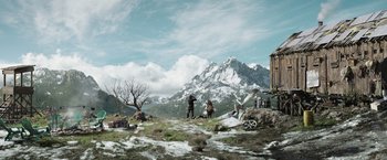 Movie still from “Love and Monsters” (2020), directed by Michael Matthews – A man standing on top of a snow covered hill; Extreme Wide shot, Low angle