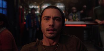 Movie still from “Love Hard” (2021), directed by Hernán Jiménez – A person wearing a hat; Close Up shot, Over the shoulder angle