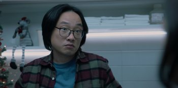 Movie still from “Love Hard” (2021), directed by Hernán Jiménez – A man with glasses is looking at the camera; Close Up shot, Over the shoulder angle