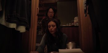 Movie still from “Love Hard” (2021), directed by Hernán Jiménez – Two women sitting at a table in front of a computer; Medium shot, Over the shoulder angle