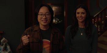 Movie still from “Love Hard” (2021), directed by Hernán Jiménez – A man and a woman smiling for the camera; Medium shot, Over the shoulder angle