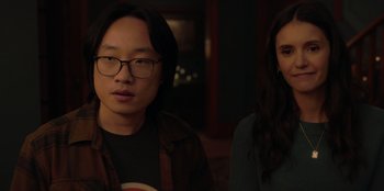 Movie still from “Love Hard” (2021), directed by Hernán Jiménez – A man and a woman standing next to each other in a room; Close Up shot, Over the shoulder angle