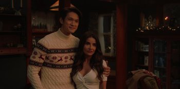 Movie still from “Love Hard” (2021), directed by Hernán Jiménez – A man and a woman posing for a picture; Medium shot, Over the shoulder angle