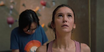 Movie still from “Love Hard” (2021), directed by Hernán Jiménez – A woman looking up into the sky while another woman looks on; Close Up shot, Low angle