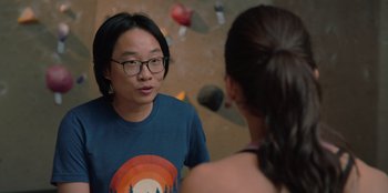 Movie still from “Love Hard” (2021), directed by Hernán Jiménez – A man and a woman talking in front of a rock wall; Close Up shot, Over the shoulder angle