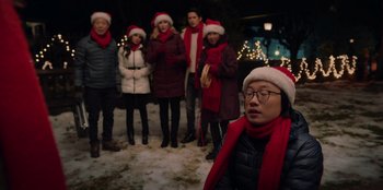Movie still from “Love Hard” (2021), directed by Hernán Jiménez – A group of people standing in the middle of a snowy field; Medium shot, Over the shoulder angle
