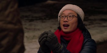 Movie still from “Love Hard” (2021), directed by Hernán Jiménez – A man wearing a red scarf and a white hat and gloves; Close Up shot, Over the shoulder angle