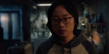 Movie still from “Love Hard” (2021), directed by Hernán Jiménez – A young man with glasses is looking at the camera; Close Up shot, Low angle