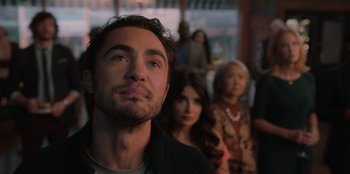 Movie still from “Love Hard” (2021), directed by Hernán Jiménez – A group of people standing in front of a building; Close Up shot, Over the shoulder angle