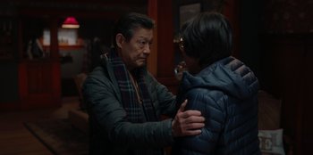 Movie still from “Love Hard” (2021), directed by Hernán Jiménez – A man and a woman standing next to each other; Medium shot, Over the shoulder angle