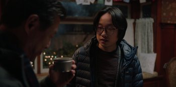 Movie still from “Love Hard” (2021), directed by Hernán Jiménez – A man holding a coffee cup talking to another man; Close Up shot, Over the shoulder angle