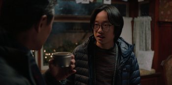 Movie still from “Love Hard” (2021), directed by Hernán Jiménez – A man holding a cup of coffee talking to another man; Close Up shot, Over the shoulder angle