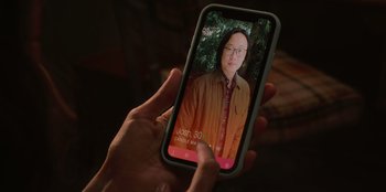 Movie still from “Love Hard” (2021), directed by Hernán Jiménez – A person holding up a cell phone to take a picture; Extreme Close Up shot, High angle