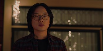 Movie still from “Love Hard” (2021), directed by Hernán Jiménez – A person wearing glasses and a plaid shirt; Close Up shot, Over the shoulder angle