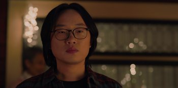 Movie still from “Love Hard” (2021), directed by Hernán Jiménez – A man with glasses is looking at the camera; Close Up shot, Low angle