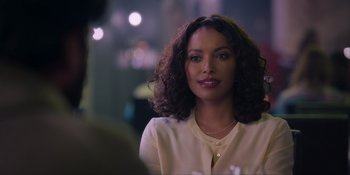 Movie still from “Love in the Villa” (2022), directed by Mark Steven Johnson – A woman with curly brown hair wearing a white shirt; Close Up shot, Over the shoulder angle