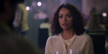 Movie still from “Love in the Villa” (2022), directed by Mark Steven Johnson – A woman in a white shirt is standing in a room; Close Up shot, Over the shoulder angle