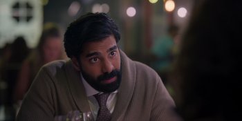 Movie still from “Love in the Villa” (2022), directed by Mark Steven Johnson – A man with a beard is sitting at a table; Close Up shot, Over the shoulder angle
