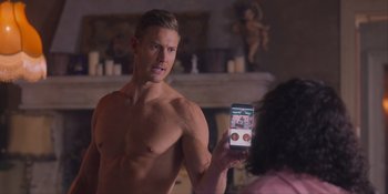 Movie still from “Love in the Villa” (2022), directed by Mark Steven Johnson – A man taking a picture of himself in the mirror; Medium shot, Over the shoulder angle