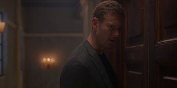 Movie still from “Love in the Villa” (2022), directed by Mark Steven Johnson – A person wearing a suit and tie; Close Up shot, Low angle