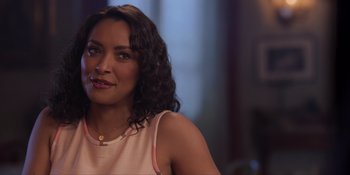 Movie still from “Love in the Villa” (2022), directed by Mark Steven Johnson – A person wearing a necklace; Close Up shot, Over the shoulder angle