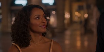 Movie still from “Love in the Villa” (2022), directed by Mark Steven Johnson – A beautiful woman with curly black hair looking up at the sky; Close Up shot, Over the shoulder angle
