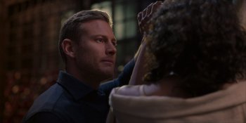 Movie still from “Love in the Villa” (2022), directed by Mark Steven Johnson – A person looking at something on the ground; Close Up shot, Over the shoulder angle