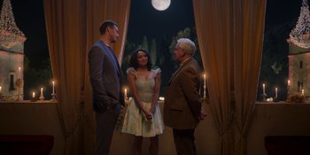 Movie still from “Love in the Villa” (2022), directed by Mark Steven Johnson – A man and a woman standing next to each other in front of a window; Wide shot, Over the shoulder angle