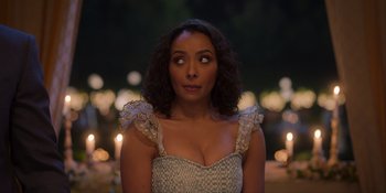 Movie still from “Love in the Villa” (2022), directed by Mark Steven Johnson – A woman in a white dress is looking at the camera; Close Up shot, Over the shoulder angle