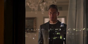 Movie still from “Love in the Villa” (2022), directed by Mark Steven Johnson – A man standing in a room looking at the camera; Close Up shot, Over the shoulder angle